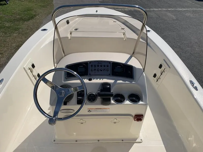 Slide: The Image of 2025 Scout 177 Sport boat with open storage compartment and cooler. - 14