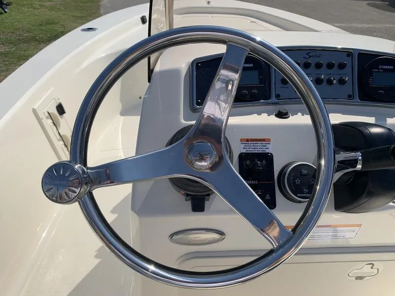 Slide: The Image of 2025 Scout 177 Sport boat dashboard with steering wheel and control panel. - 15