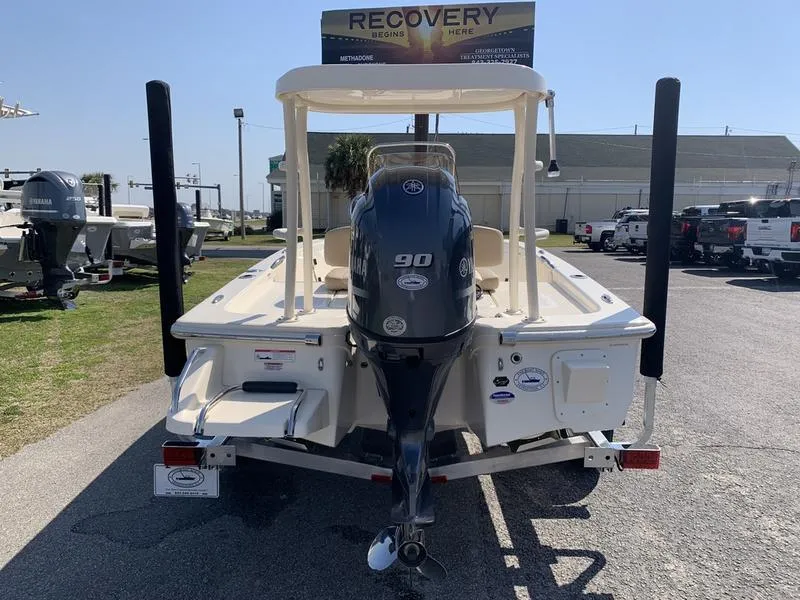 Slide: The Image of 2025 Scout 177 Sport boat with Yamaha engine on trailer in sunny outdoor setting. - 2