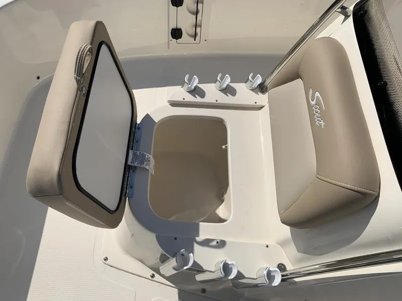 Slide: The Image of 2025 Scout 177 Sport boat interior with beige seating and steering console. - 23