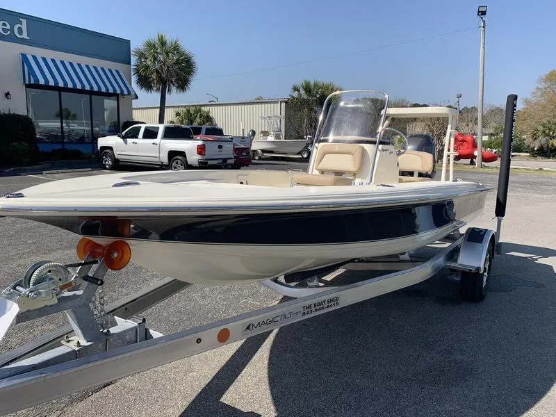 Slide: The Image of 2025 Scout 177 Sport boat displayed outdoors on a sunny day. - 7