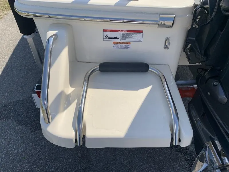 Slide: The Image of 2025 Scout 177 Sport boat on trailer in sunny outdoor setting. - 8