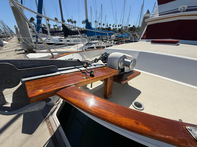 Slide: The Image of 1983 Californian 34 yacht deck with polished wood and anchor winch. - 10