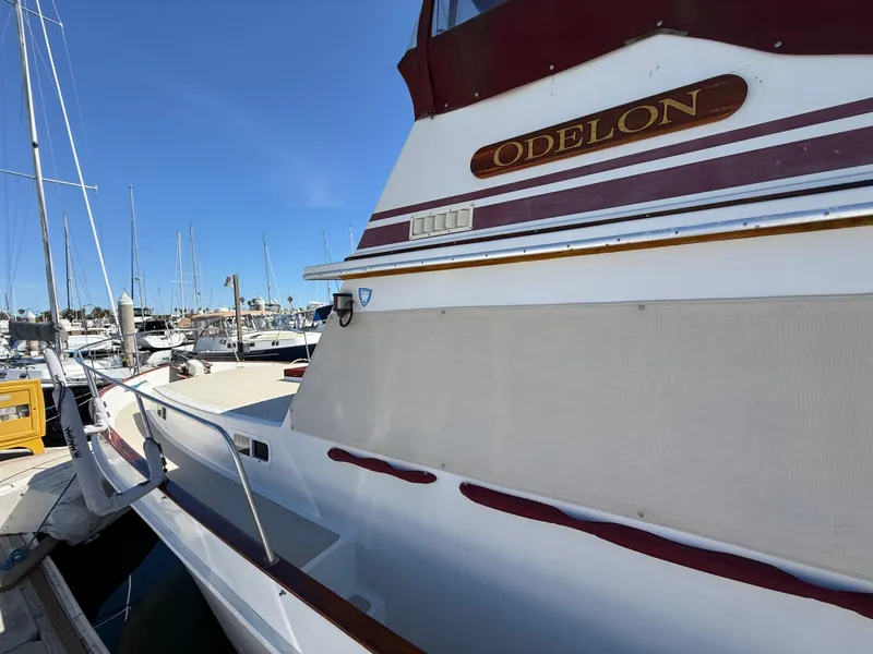 Slide: The Image of 1983 Californian 34 yacht docked at marina, featuring "ODELON" nameplate. - 14
