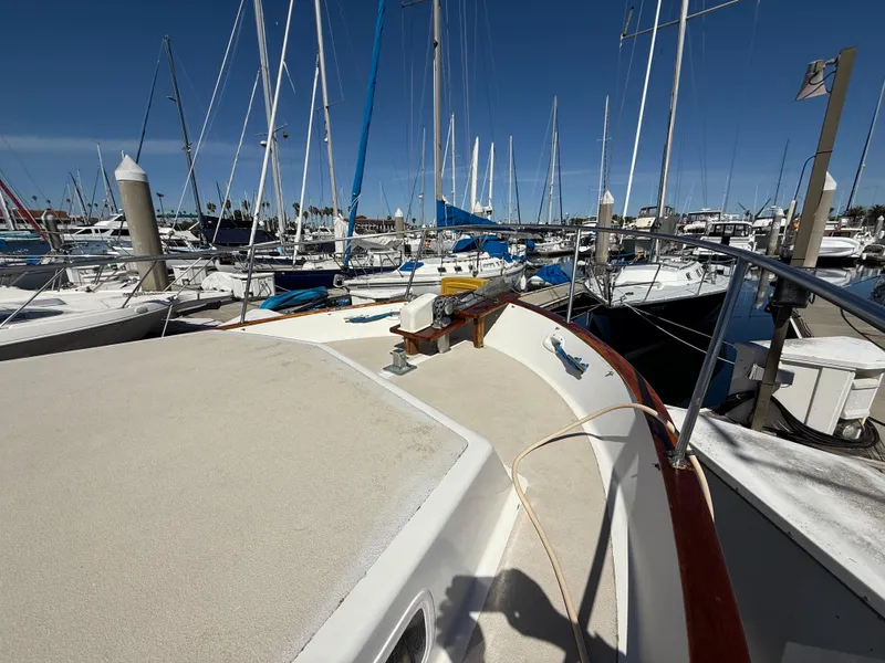 Slide: The Image of 1983 Californian 34 yacht docked in a marina with numerous sailboats. - 17