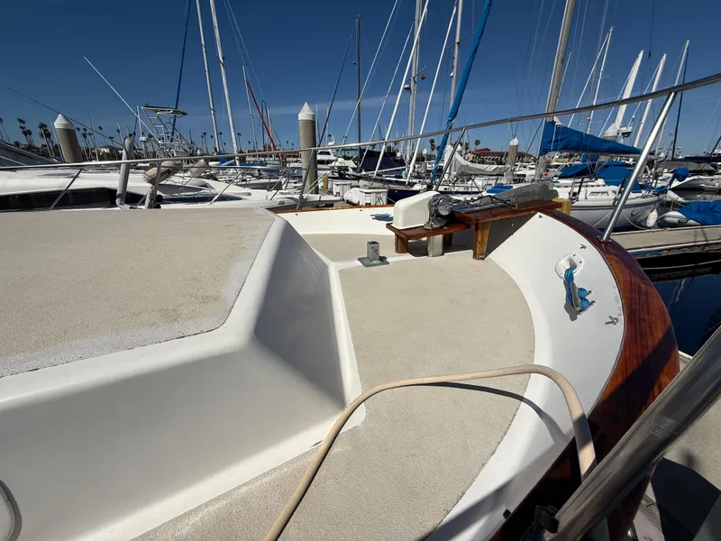 Slide: The Image of 1983 Californian 34 yacht deck in marina, surrounded by sailboats under clear blue sky. - 22