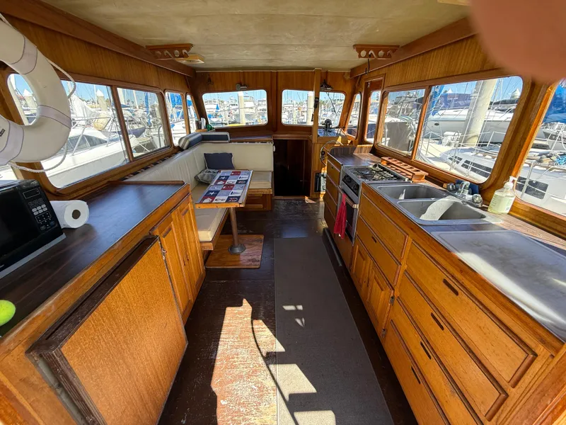 Slide: The Image of Interior of 1983 Californian 34 yacht with wooden cabinetry and kitchen area. - 26