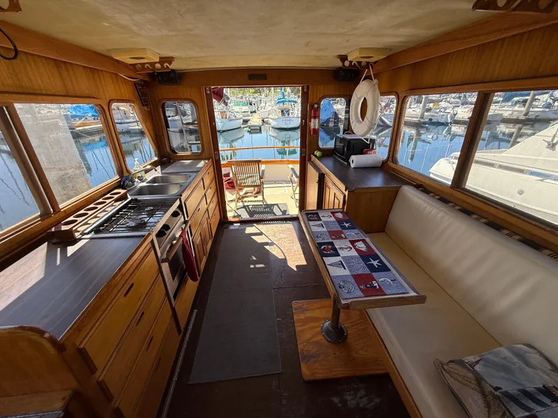 Slide: The Image of Interior of a 1983 Californian 34 boat with kitchen and seating area. - 29