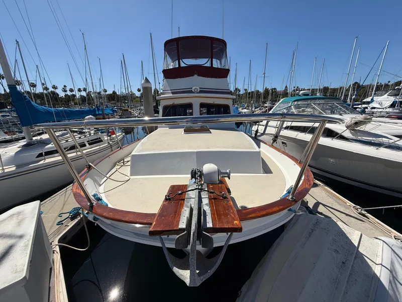 Slide: The Image of 1983 Californian 34 yacht docked in marina, surrounded by sailboats under clear blue sky. - 3