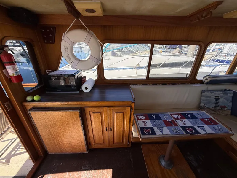 Slide: The Image of Interior of a 1983 Californian 34 boat with wooden cabinetry and nautical decor. - 32
