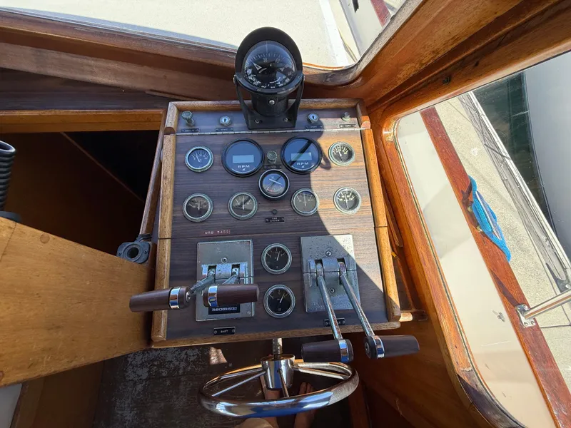 Slide: The Image of Control panel of a 1983 Californian 34 boat with gauges and steering wheel. - 33