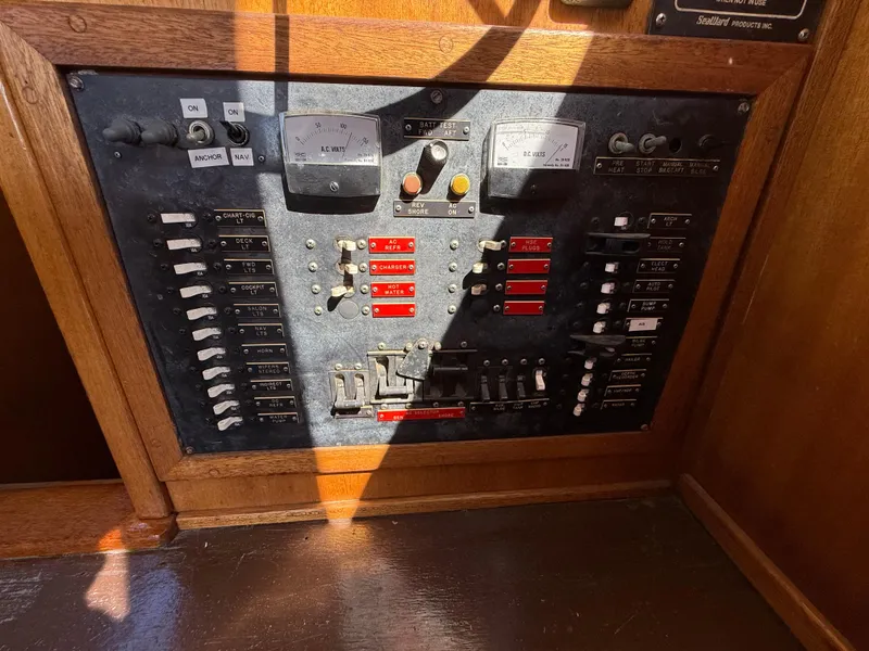 Slide: The Image of Electrical control panel on a 1983 Californian 34 boat, featuring switches and meters. - 34