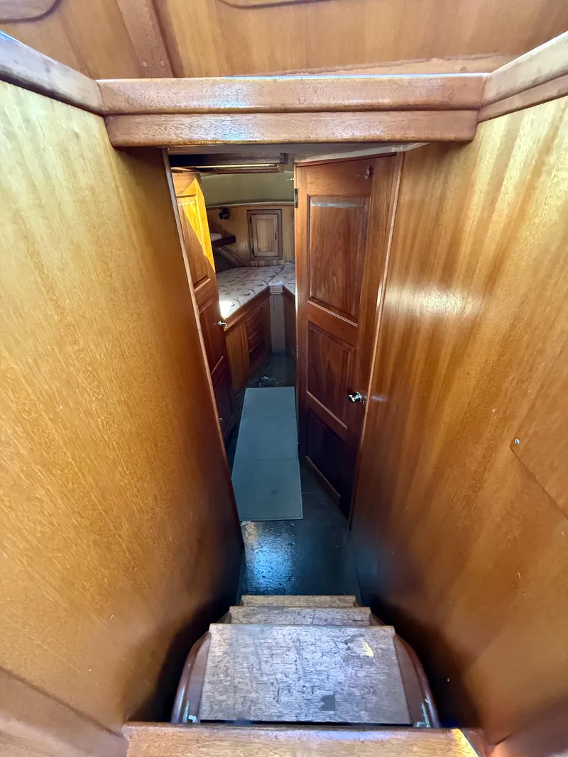 Slide: The Image of Interior view of 1983 Californian 34 yacht, featuring wooden paneling and cabin entryway. - 38