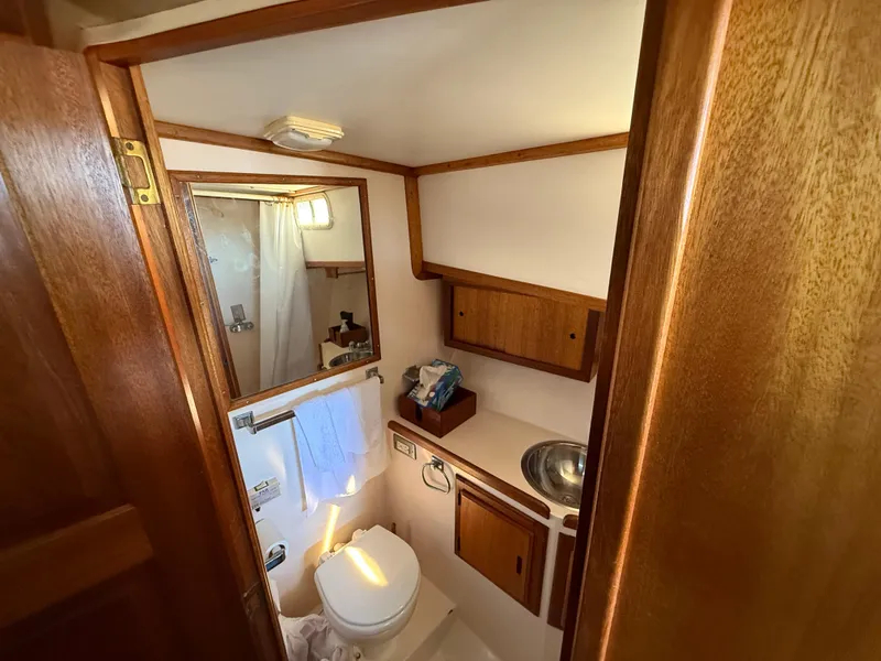 Slide: The Image of 1983 Californian 34 yacht bathroom with wooden cabinetry and compact design. - 42