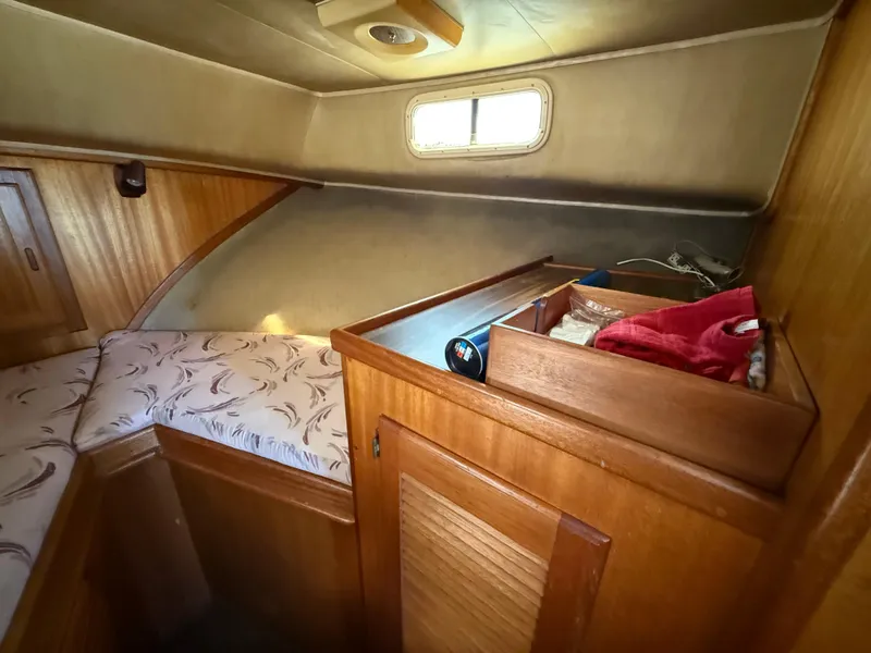 Slide: The Image of 1983 Californian 34 yacht cabin interior with wooden finish and cozy sleeping area. - 46