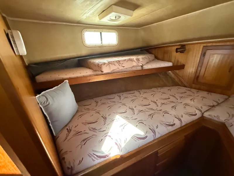 Slide: The Image of Cozy cabin interior of 1983 Californian 34 yacht with twin beds and wooden finish. - 47