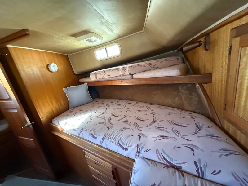 Slide: The Image of Cozy cabin interior of 1983 Californian 34 boat with wooden furnishings and bunk beds. - 48
