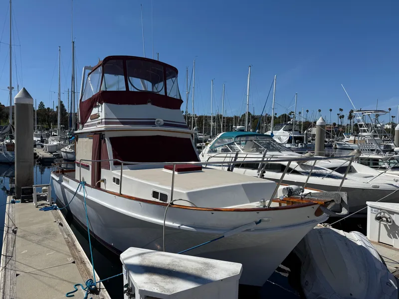Slide: The Image of 1983 Californian 34 yacht docked in marina under clear blue sky. - 5
