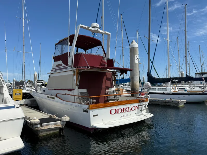 Slide: The Image of 1983 Californian 34 yacht docked at marina under clear blue sky. - 8