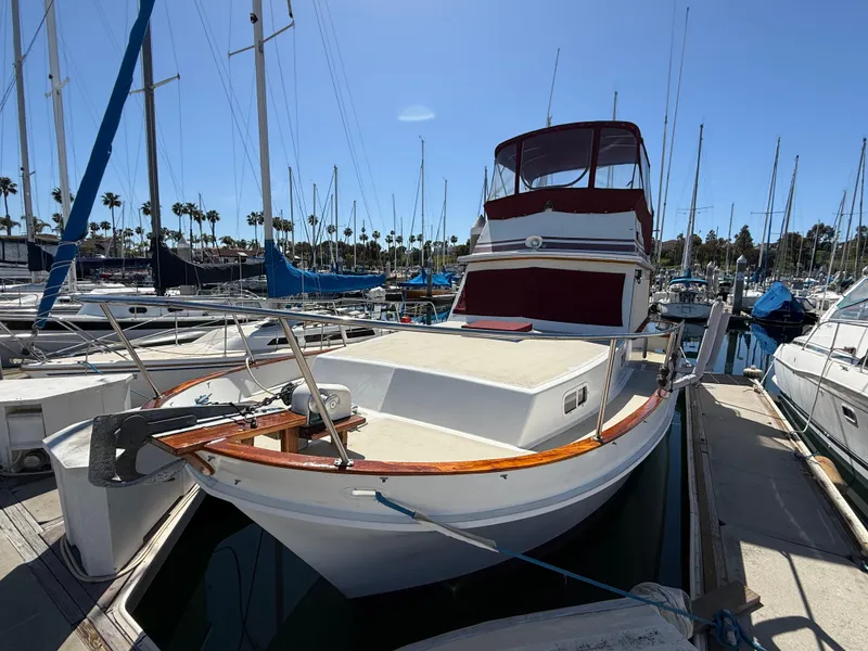 Slide: The Image of 1983 Californian 34 yacht docked in marina, surrounded by sailboats under clear blue sky. - 9