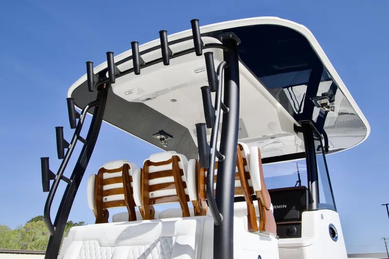 Slide: The Image of 2025 Regulator 35 boat with sleek design and modern seating under a clear blue sky. - 12