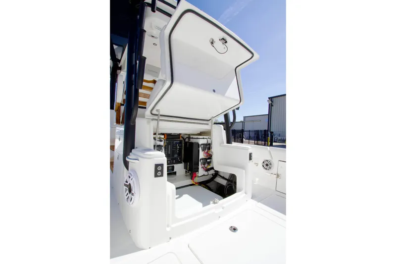 Slide: The Image of 2025 Regulator 35 boat showing open hatch with electrical components and storage area. - 14