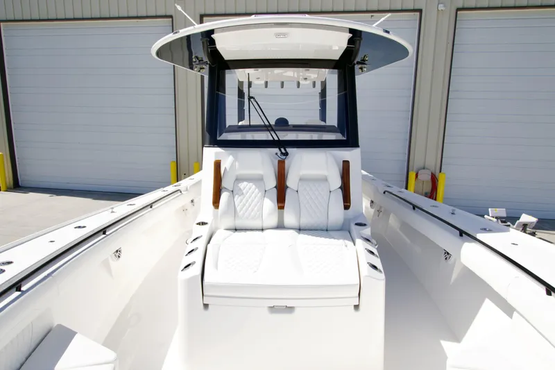 Slide: The Image of 2025 Regulator 35 boat with sleek white seating and modern design in a marina setting. - 17