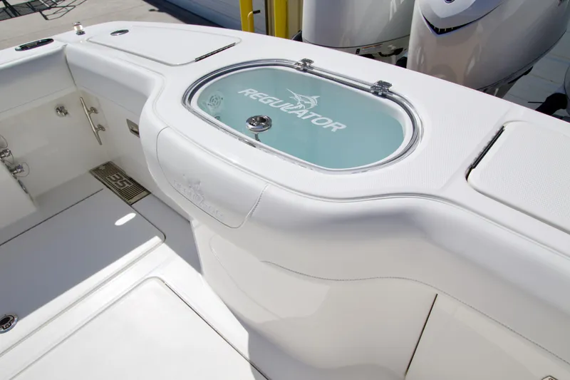 Slide: The Image of 2025 Regulator 35 boat interior with branded livewell and sleek white design. - 8
