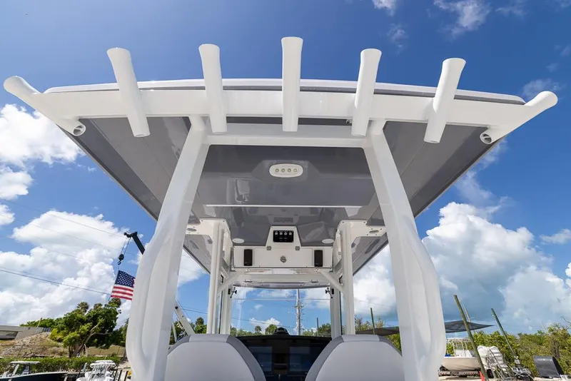 Slide: The Image of 2026 Sea Fox 288 Commander boat with T-top against a blue sky background. - 14