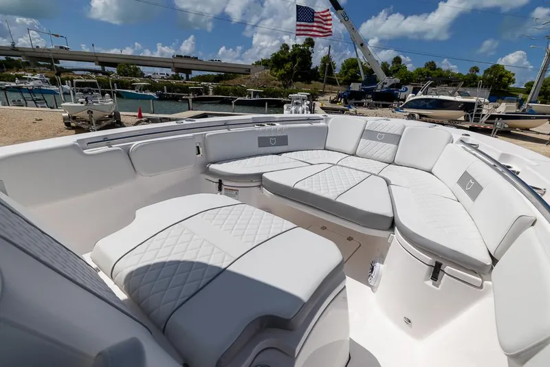 Slide: The Image of 2026 Sea Fox 288 Commander boat with luxurious white seating and American flag in background. - 21