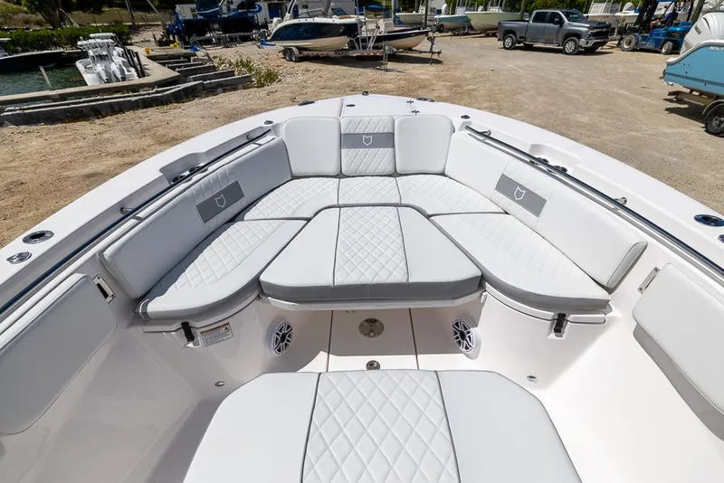Slide: The Image of 2026 Sea Fox 288 Commander boat with spacious, cushioned seating in a marina setting. - 22