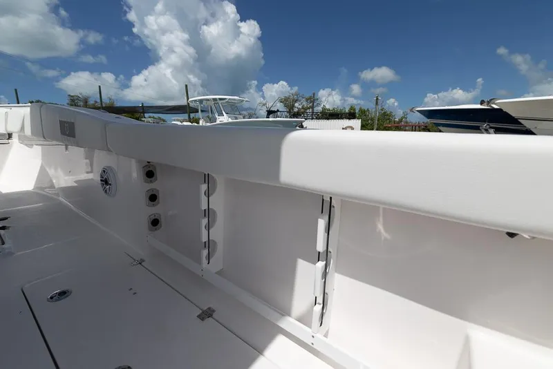 Slide: The Image of 2026 Sea Fox 288 Commander boat interior with white seating and clear blue sky. - 25