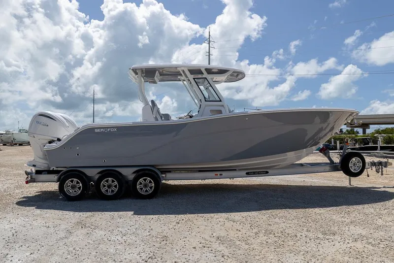 Slide: The Image of 2026 Sea Fox 288 Commander boat on trailer under cloudy sky. - 5