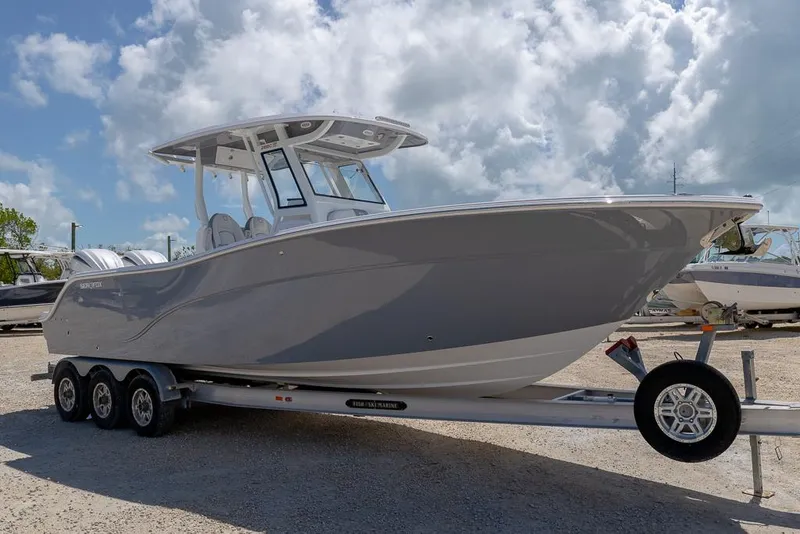 Slide: The Image of 2026 Sea Fox 288 Commander boat on trailer under cloudy sky. - 6