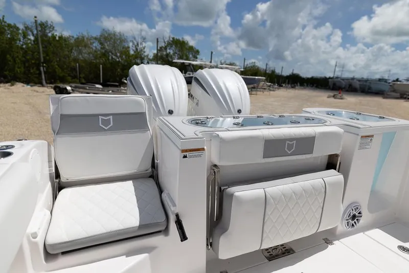 Slide: The Image of 2026 Sea Fox 288 Commander boat interior with white seating and dual engines. - 9