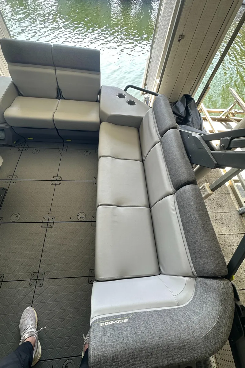 Slide: The Image of 2022 Sea-Doo Switch Cruise 18 interior with gray seating and water view. - 8