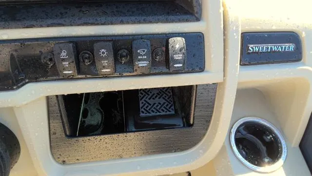 Slide: The Image of Dashboard controls of 2025 Godfrey Pontoons Sweetwater 2086 SB with cup holder. - 12