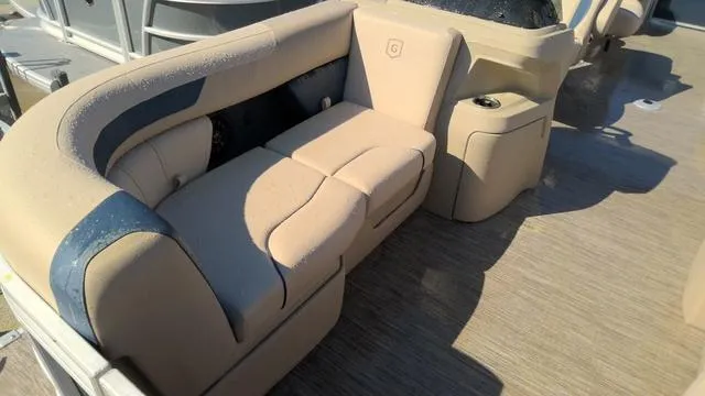 Slide: The Image of 2025 Godfrey Pontoons Sweetwater 2086 SB interior seating with beige upholstery and cup holder. - 2