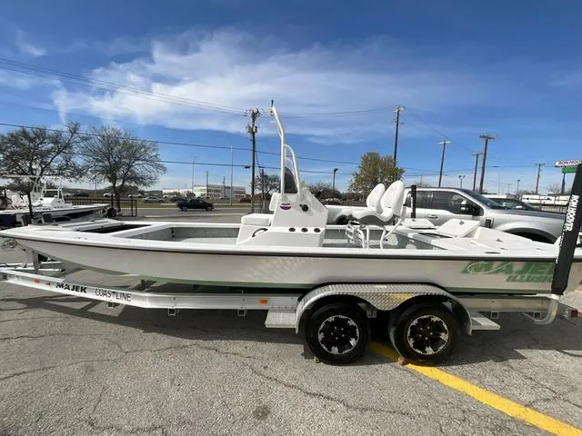 Slide: The Image of 2025 Majek 2206 Illusion boat on trailer, parked outdoors under clear sky. - 1