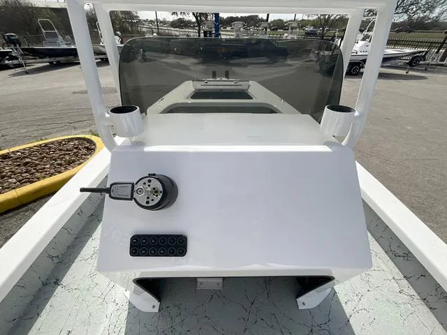 Slide: The Image of 2025 Majek 2206 Illusion boat console with steering wheel and controls, parked outdoors. - 10