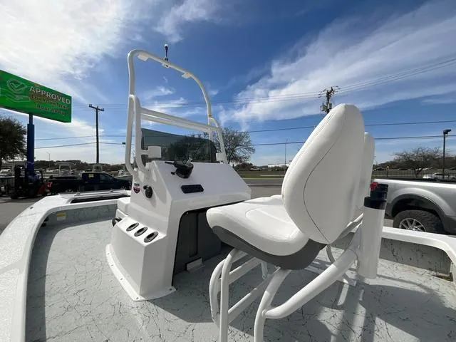 Slide: The Image of 2025 Majek 2206 Illusion boat with white seating and console, under a clear blue sky. - 11