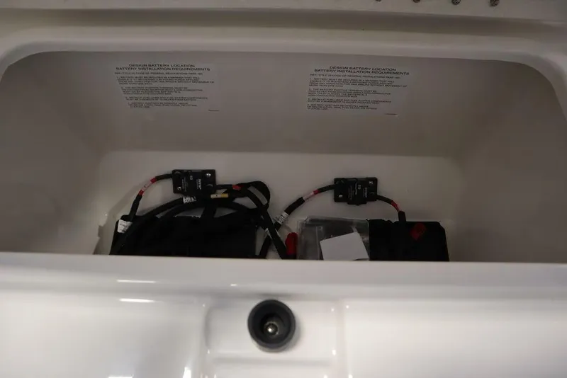 Slide: The Image of 2025 Bayliner 22 CC TROPHY battery compartment with wiring and components. - 10