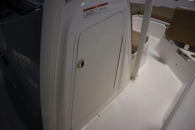 Slide: The Image of 2025 Bayliner 22 CC Trophy boat interior with seating and storage compartment. - 12