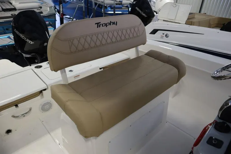 Slide: The Image of 2025 Bayliner 22 CC Trophy boat seat with beige upholstery and "Trophy" logo. - 15