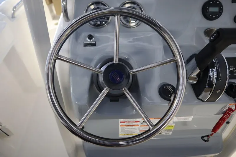 Slide: The Image of Steering wheel of 2025 Bayliner 22 CC Trophy boat, featuring modern controls and gauges. - 16