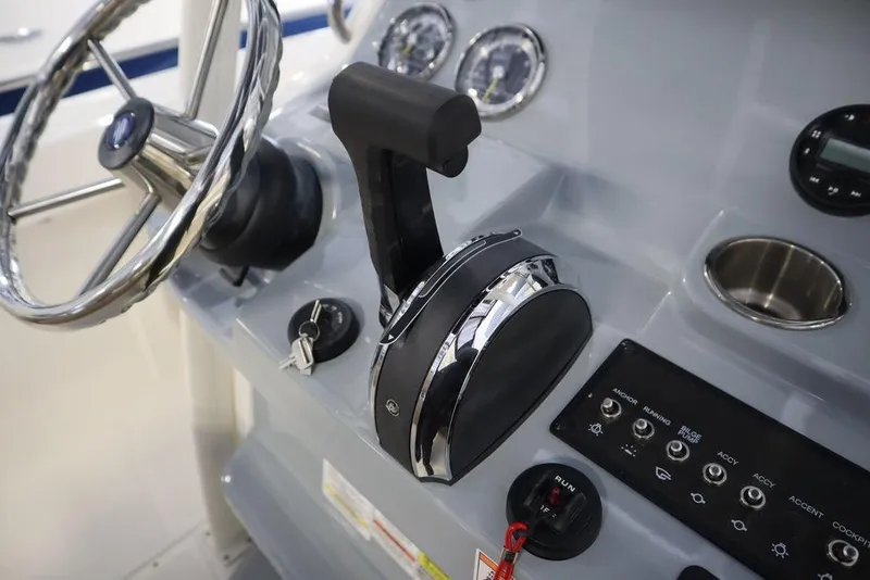 Slide: The Image of Control panel of 2025 Bayliner 22 CC Trophy boat with steering wheel and throttle. - 20