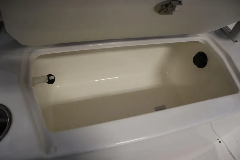 Slide: The Image of Open storage compartment on 2025 Bayliner 22 CC Trophy boat. - 23