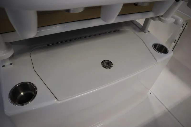 Slide: The Image of 2025 Bayliner 22 CC Trophy boat interior with storage compartment and cup holders. - 24