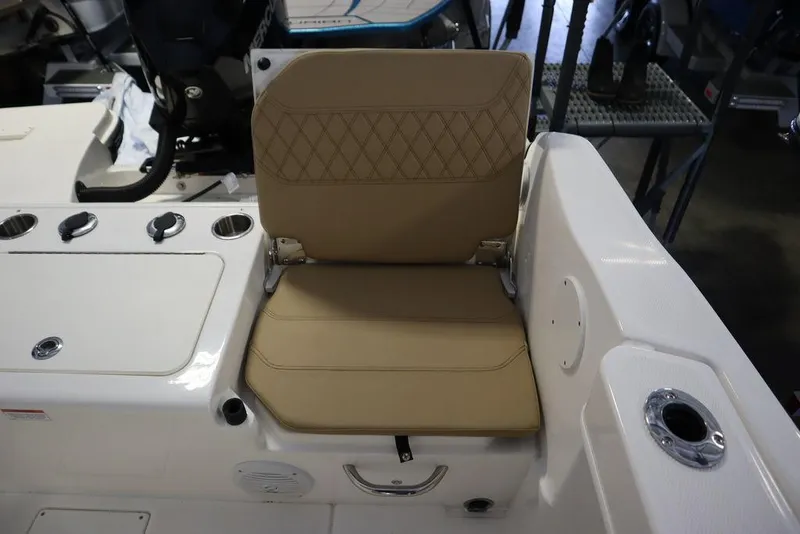 Slide: The Image of 2025 Bayliner 22 CC TROPHY boat seat with beige upholstery and diamond stitching. - 25
