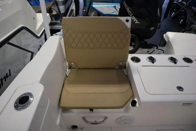 Slide: The Image of 2025 Bayliner 22 CC TROPHY boat seat with tan upholstery and diamond stitching. - 27